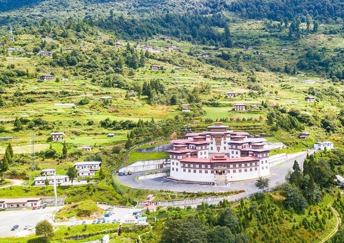 Dzong among green fields in Chukha district, Bhutan