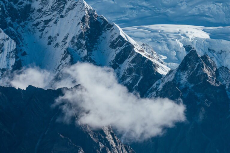 Snow-covered Himalayan peaks with clouds below