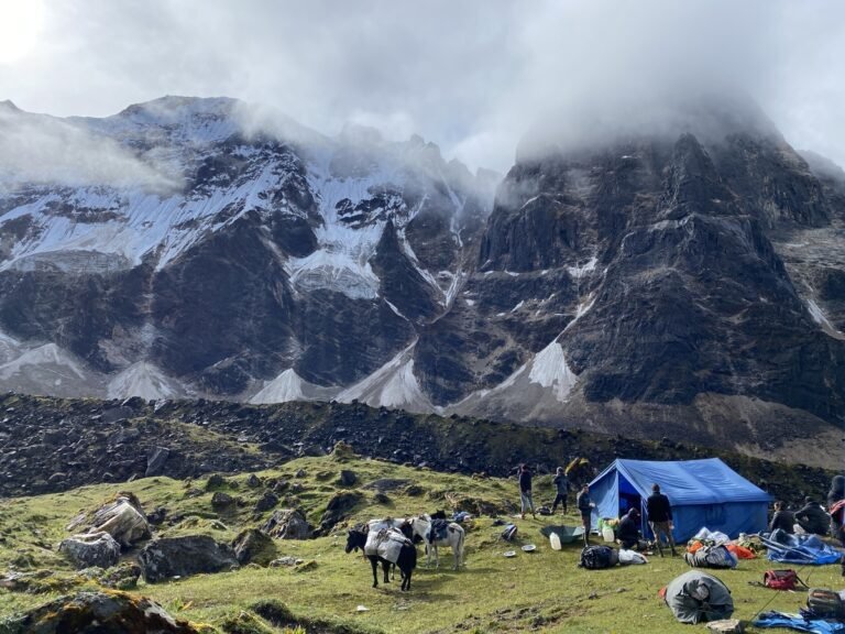 Trekking campsite below rugged snow-capped mountains, Bhutan