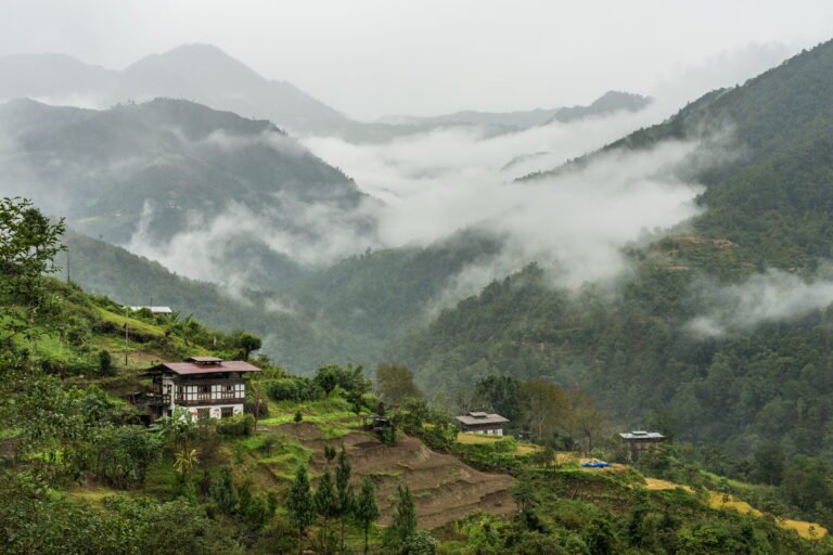 Farmhouse among misty hills on a village hike in Punakha